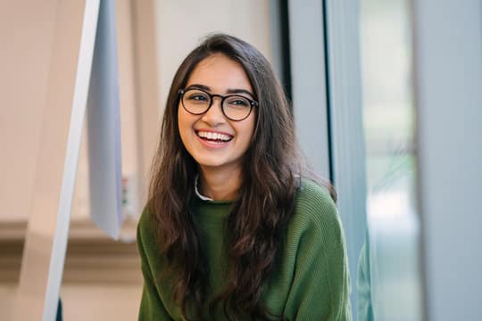 Young woman smiling with straight teeth after orthodontic treatment